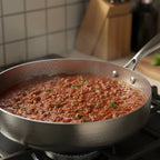 Deep cooking pan with high sidewalls and natural nonstick surface, suitable for sautéing, simmering, braising, and frying on all cooktops.