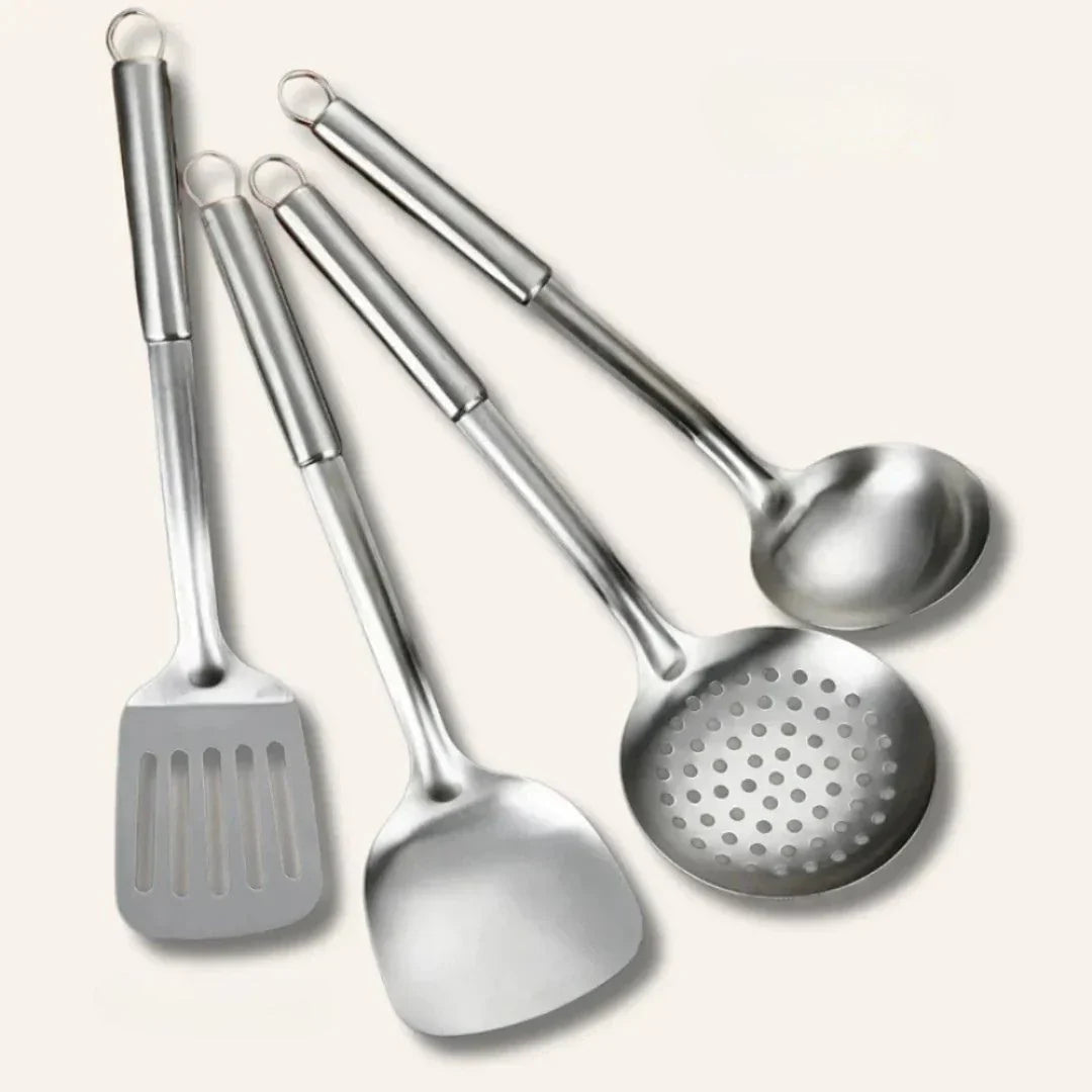 Kitchen essentials set featuring pots, utensils, and a cutting board for meal preparation, cooking, and everyday kitchen tasks.